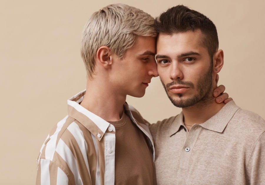 Emotional moment captured as two men hug, one making eye contact with the other.
